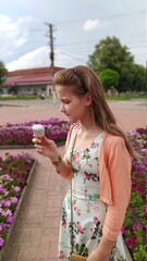 Fototapeta premium girl eating ice cream in a city park