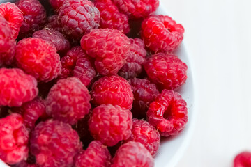bowl with fresh red raspberries.