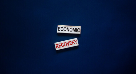 'Economic recovery' words on wooden blocks. Business concept. Beautiful black background.