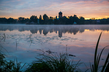 Naklejka premium island ancient monastery in the middle of the lake at sunrise