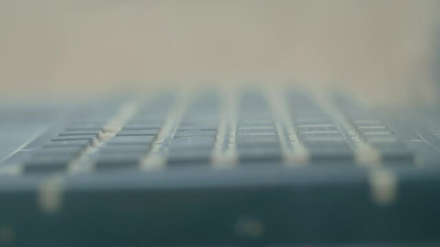 Keyboard of dustproof rugged laptop computer for military, outdoor and industrial use during dust resistance test - sand storm - close up view. Protective, resistant, safety, technology concept