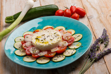 mozzarella cream with sliced zucchinis tomatoes and lavender flower