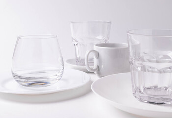 a group of different white ceramic plates on white background