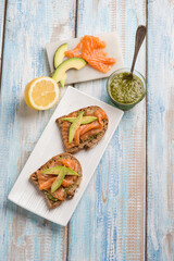 sliced bread with pesto sauce smocked salmon and avocado
