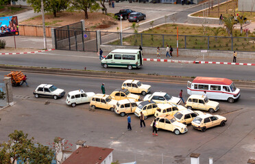 Antananarivo, Madagascar : taxi stand with yellow vintage cars 
