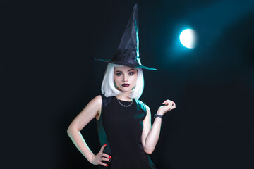 Beautiful young woman with white wig posing in witches sexy costume. Happy Halloween
