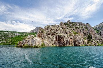 Fototapeta na wymiar Mountains along the banks of the river in the national park Krka, Croatia