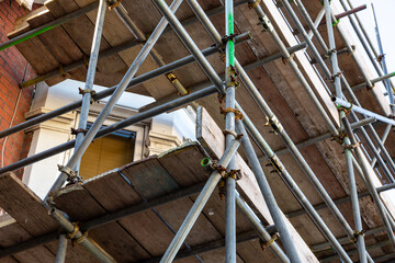a close up of scaffolding poles on a building site using selective focus