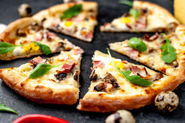Pizza carbonara with bacon, cheese, mushrooms, quail eggs, creamy sauce on a stone background