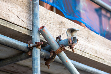 a close up of scaffolding poles on a building site using selective focus