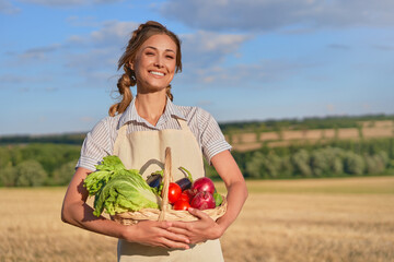 Woman farmer apron standing farmland smiling Female agronomist specialist farming agribusiness Happy positive caucasian worker agricultural field