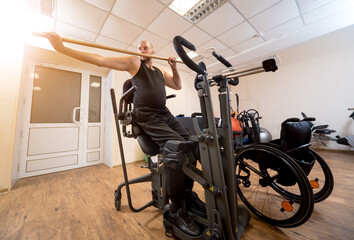 Disabled man training in the gym. Rehabilitation center