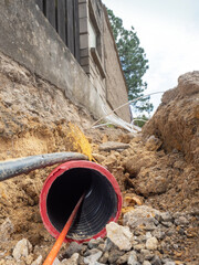 Internet optic fiber in trench. Building of lines fiber optic cables construction