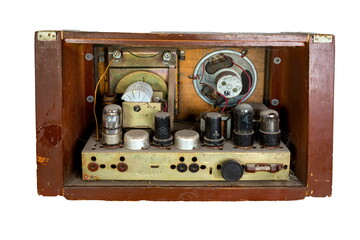 Old tubes and electric parts of an old dusty amplifier.