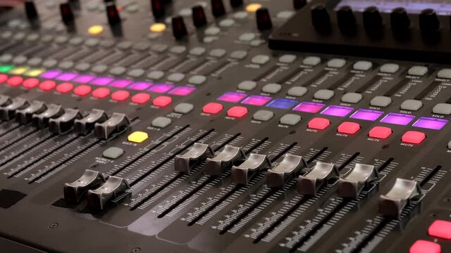 Remote control for adjusting the sound. Audio mixer. Sound engineer adjusts the sound. Music Festival. Change the volume level. Recording studio. Shooting a television show, a concert. Live broadcast