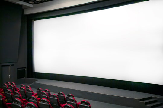 Empty Cinema Seats With Blank White Screen. Side View