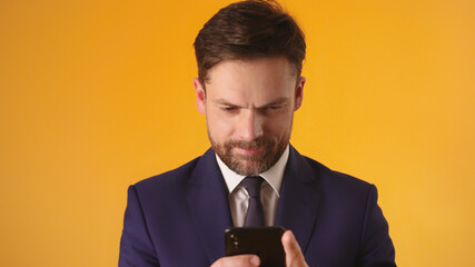 Managing a business with his smartphone. Bearded caucasian businessmen sending sms. High quality photo