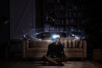Man uses virtual reality glasses to see the galaxy space. Elements of this image furnished by NASA.