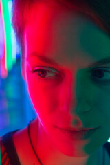 portrait of a young, beautiful woman headshot, in red and green neon light, beauty, femininity and sexuality of a female look