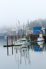 Fishing boats in fog at Newport marina on the Oregon coast