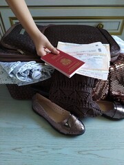 Open brown suitcase with women