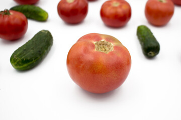 Fresh tomatoes and cucumrers on a white background, flat lay. Healthy food, vegan food.