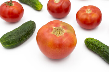 Fresh tomatoes and cucumrers on a white background, flat lay. Healthy food, vegan food.