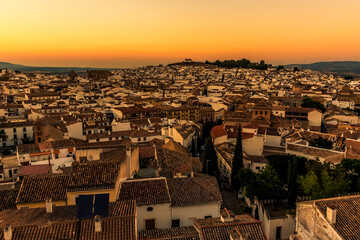Fototapeta na wymiar A panorama view across the rooftops of Antequera, Spain at sunset on a summers evening