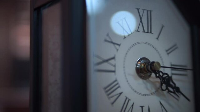 Vintage white clock face with Roman numerals close up stock footage.