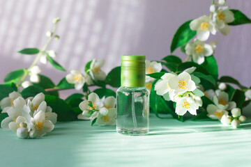 Obraz na płótnie Canvas Floral perfume with jasmine flower scent. Glass bottle, scent spray bottle with fragrance