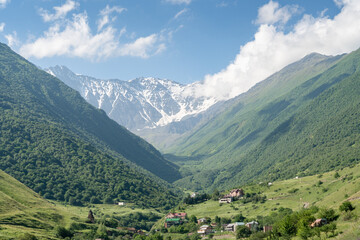 Fototapeta na wymiar View of highest mountain village in mountains with cloudy sky. Beautiful landscape Caucasus.