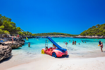 Fototapeta premium CALA MONDRAGO, Majorka, Spain, 24 July 2020 - People enjoy the beach in summer, Parque Natural de Mondrago. Santanyi. Malorca. Spain