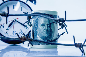 Barbed wire and US Dollar bill as symbol of economic warfare, sanctions and embargo busting.