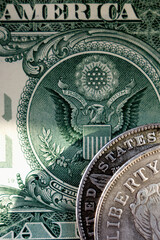 Close up old US coins and one Dollar bill as symbol: America - the land of opportunities and freedom. Selective focus on word Liberty.