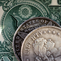 Close up old US coins with inscription: Liberty and one Dollar bill as symbol of success, wealth and business.