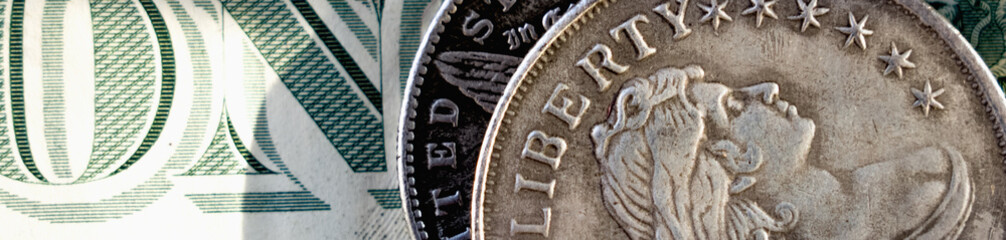 Close up old US coins with inscription: Liberty on one Dollar bill as symbol: America - the land of opportunities and freedom. Selective focus on word Liberty.