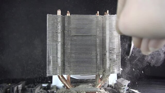 Dust pollution. Cleaning the processor radiator sink from dust. Antistatic brush. Slow motion.
