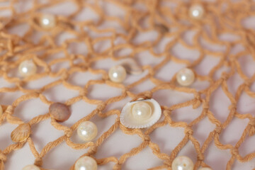 background texture fishing net with shells starfish and pearls