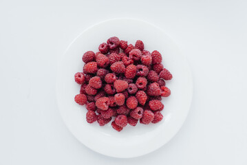 Red raspberry berries close-up on a white background. Healthy food, natural vitamins. Fresh berries