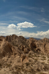 Vertical photo. Arid landscape. Geology. View of the dry valley, sandstone and rocky hills.