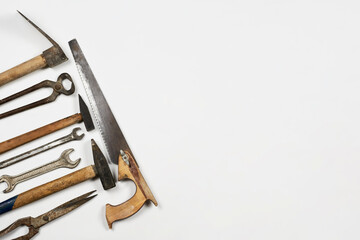 Old and rustic handy working tools on the white background with copy space on the right