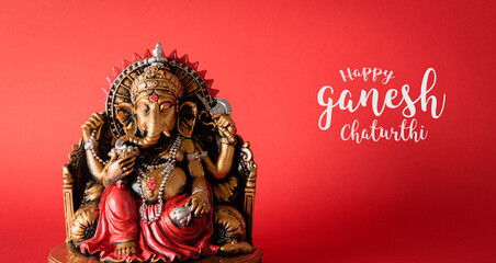 Happy Ganesh Chaturthi festival, Bronze Ganesha statue and Golden texture with flowers, Ganesh is hindu god of Success. - obrazy, fototapety, plakaty