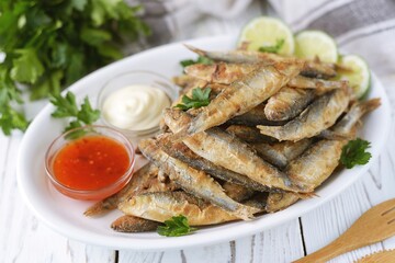 Grilled little fish in cornmeal and lime. On an old wooden background.