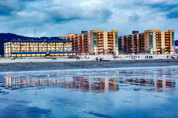 Hotels and people on the beach at sunset at Seaside, Oregon