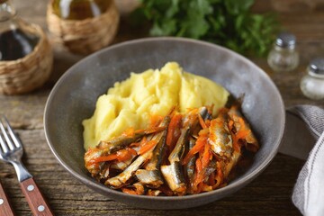 Braised anchovy in tomato sauce with onions and carrots and mashed potatoes.