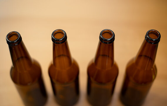 Four dark empty beer bottles.