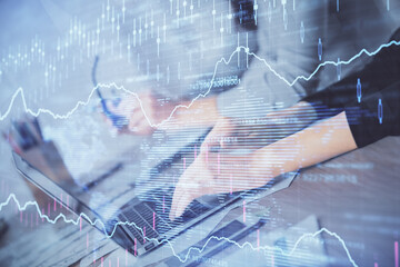 Multi exposure of woman hands typing on computer and financial chart hologram drawing. Stock market analysis concept.