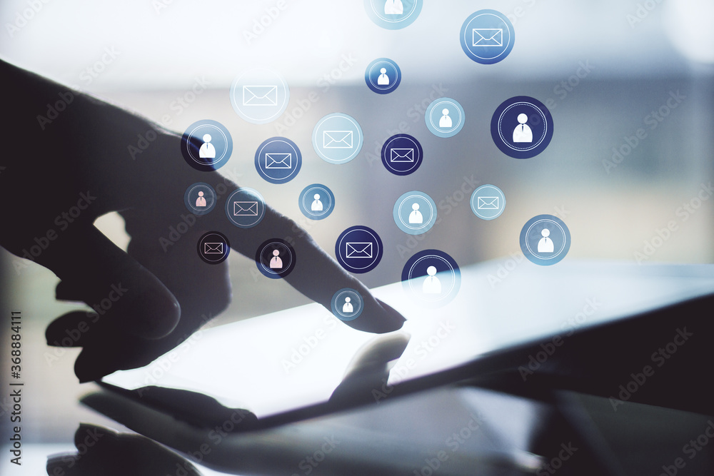 Poster Hand using digital tablet with glowing email network symbol.
