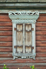 Old house vintage carved windows with wooden lacy shutters close up