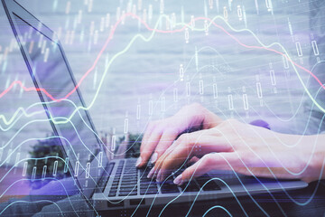 Multi exposure of woman hands typing on computer and forex chart hologram drawing. Stock market analysis concept.